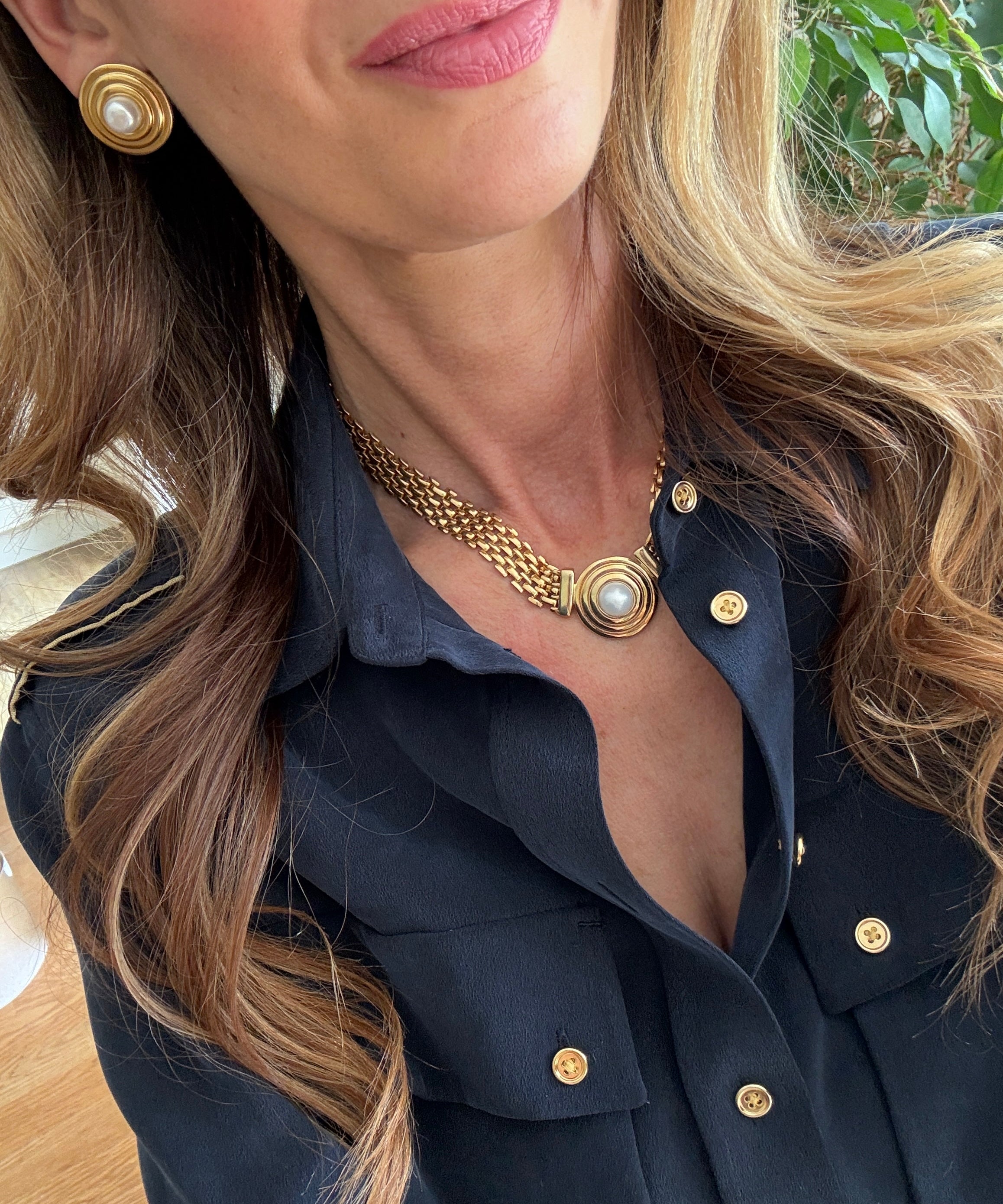 pearl and gold earrings and necklae being worn- close up shot 