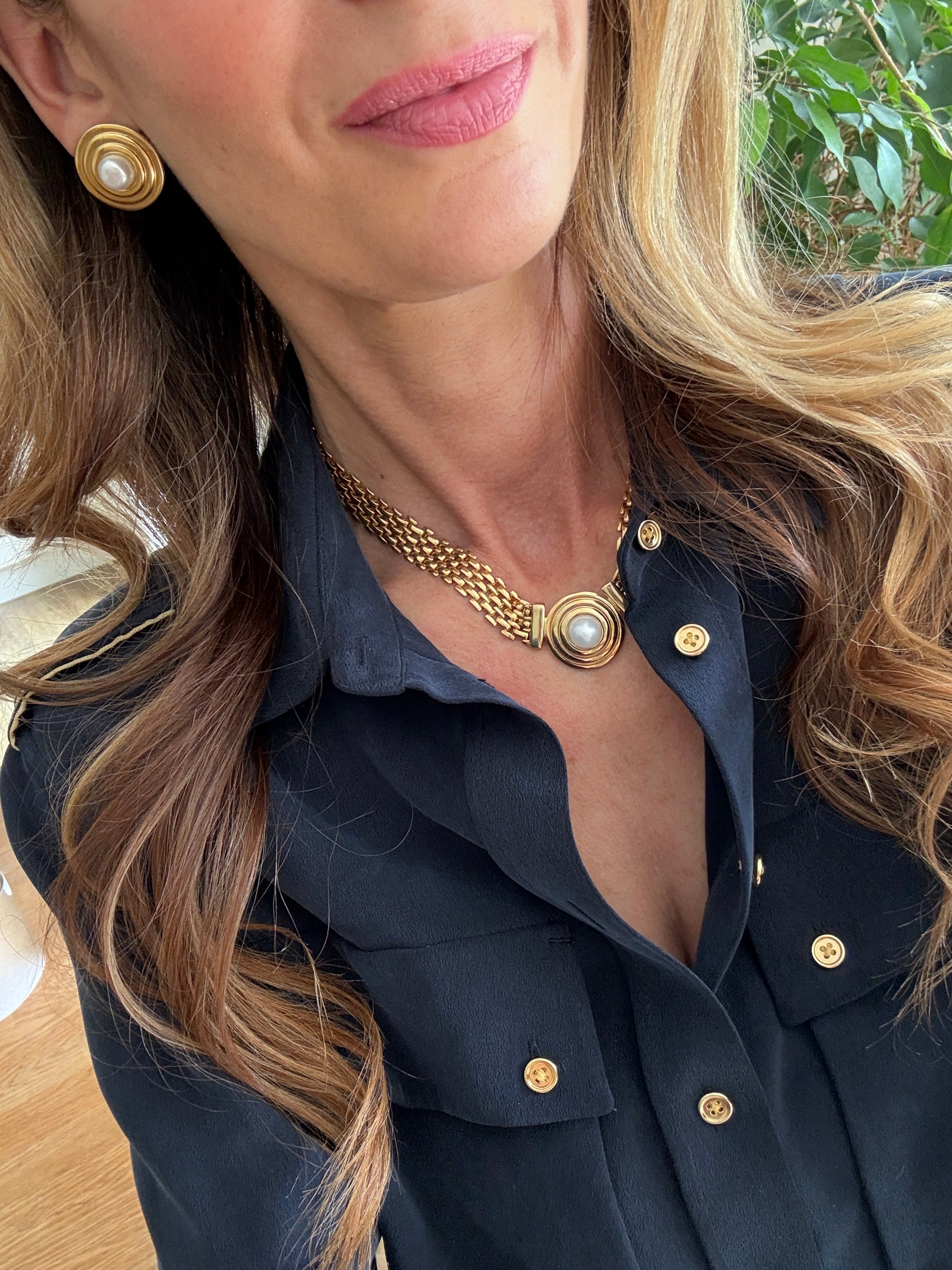 pearl and gold earrings and necklae being worn- close up shot 