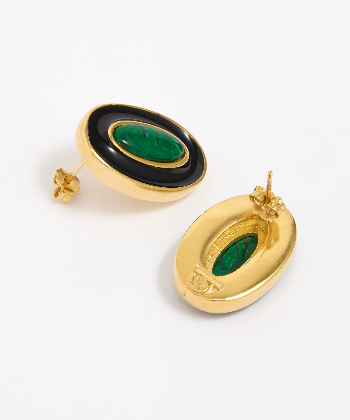 Close up of side and reverse product shot of gold earrings with green malachite stone and black enamel on a white background
