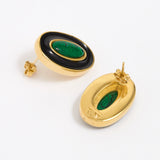 Close up of side and reverse product shot of gold earrings with green malachite stone and black enamel on a white background