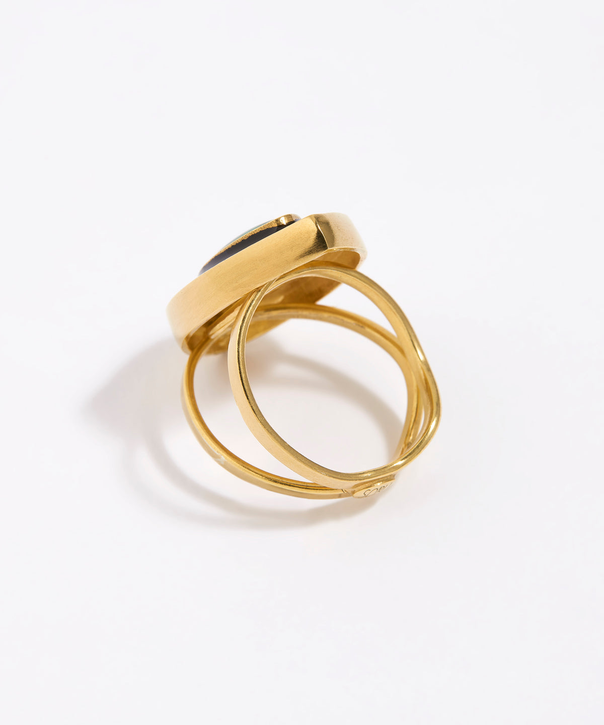 image shows back of Gold ring with a green malachite gemstone and black enamel surround on a white background