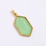 Green pendant with gold frame on a white background