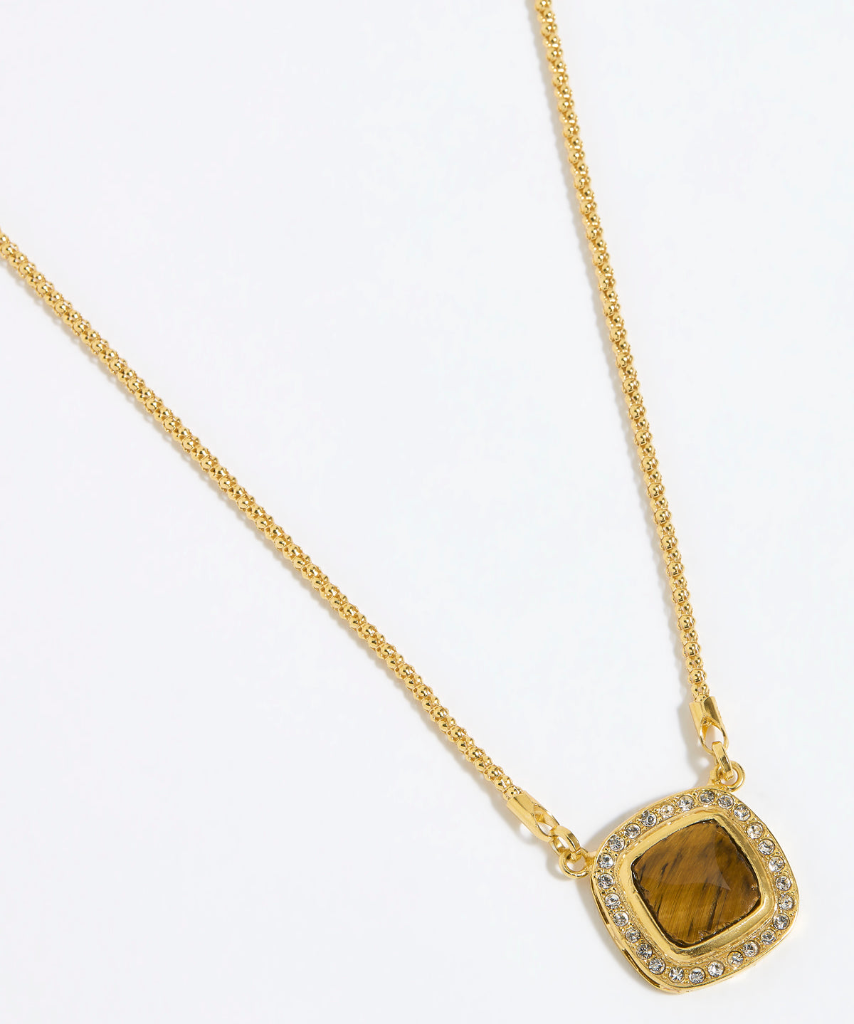 Gold necklace with a BROWN TIGERS EYE STONE SURROUNDED BY CRYSTALS ON A GOLD CHAIN on a white background