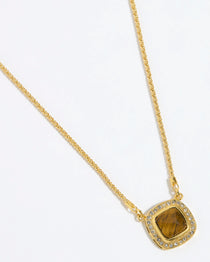 Gold necklace with a BROWN TIGERS EYE STONE SURROUNDED BY CRYSTALS ON A GOLD CHAIN on a white background