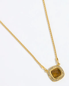 Gold necklace with a BROWN TIGERS EYE STONE SURROUNDED BY CRYSTALS ON A GOLD CHAIN on a white background