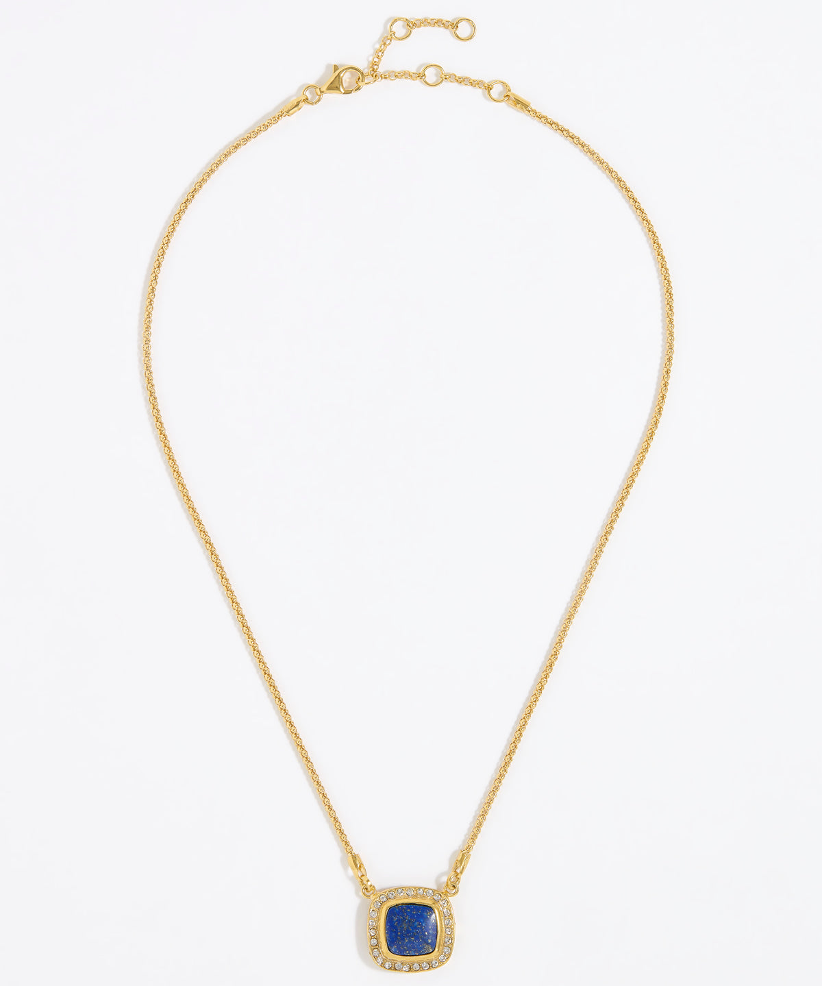 Gold necklace with a square blue pendant surrounded by crystals , on a white background