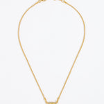 Gold necklace with a square blue pendant surrounded by crystals , on a white background