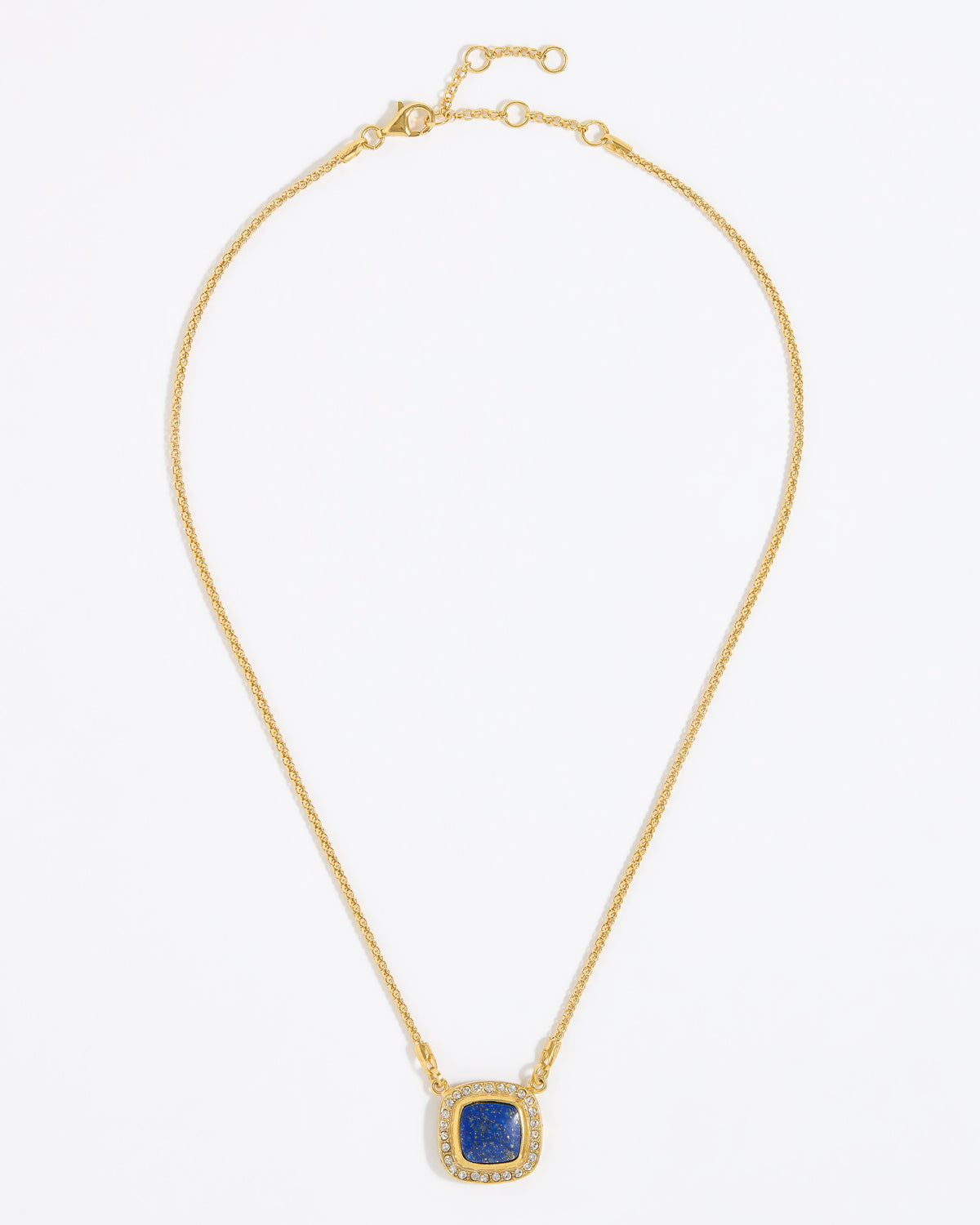 Gold necklace with a square blue pendant surrounded by crystals , on a white background