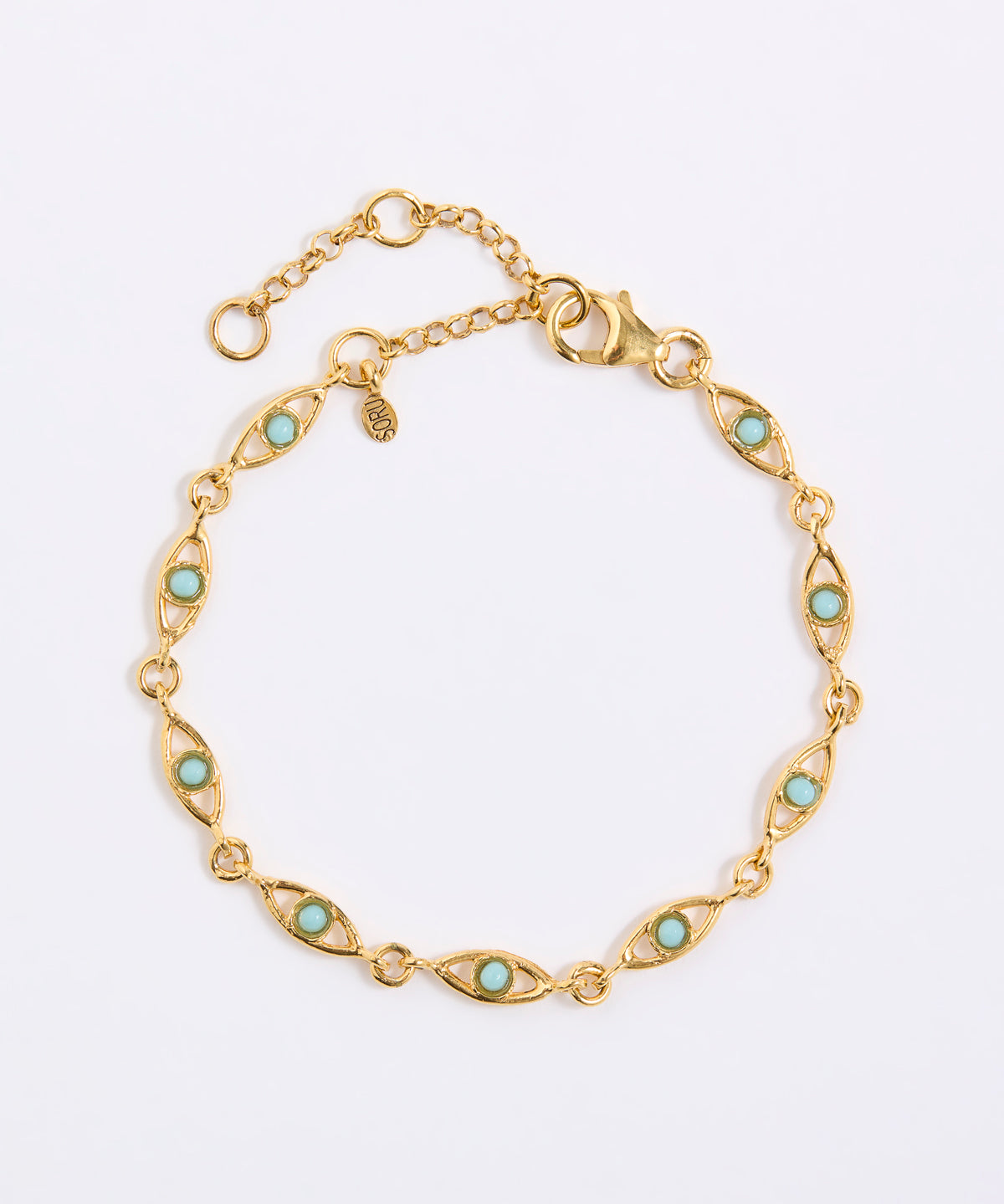 Gold bracelet with evil eye shape with turquoise stones on a light gray background