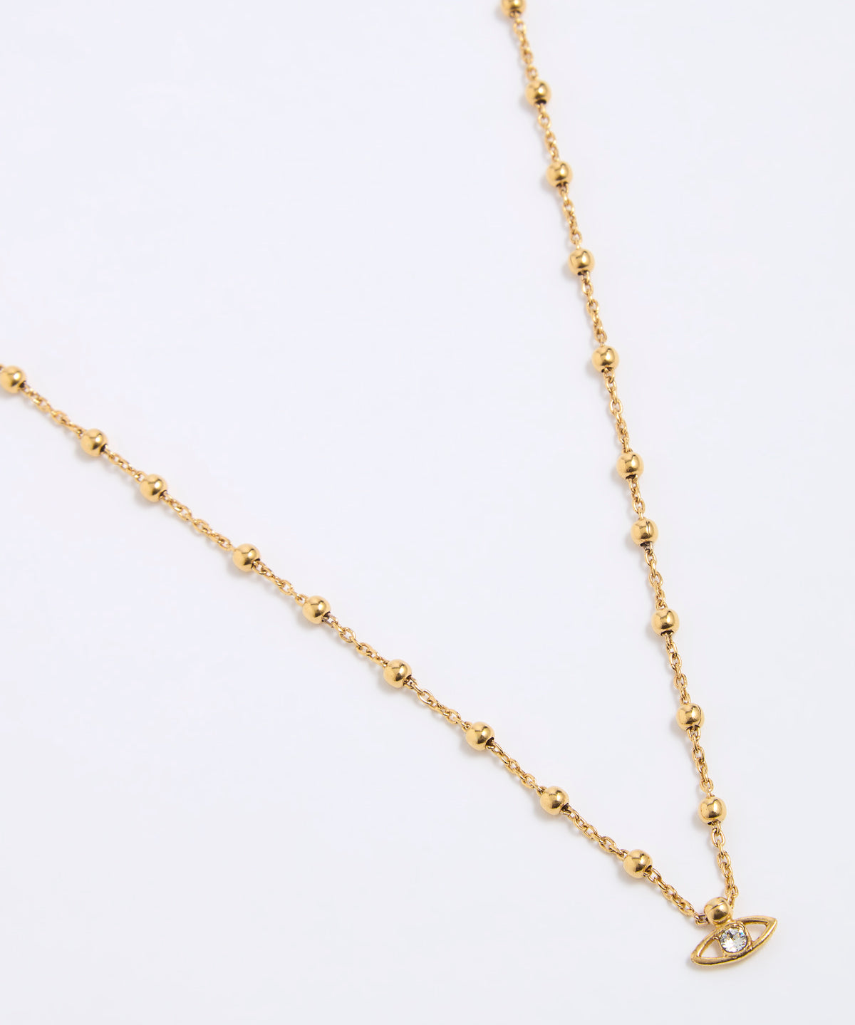 Gold coloured necklace with a small evil eye pendant on a white background