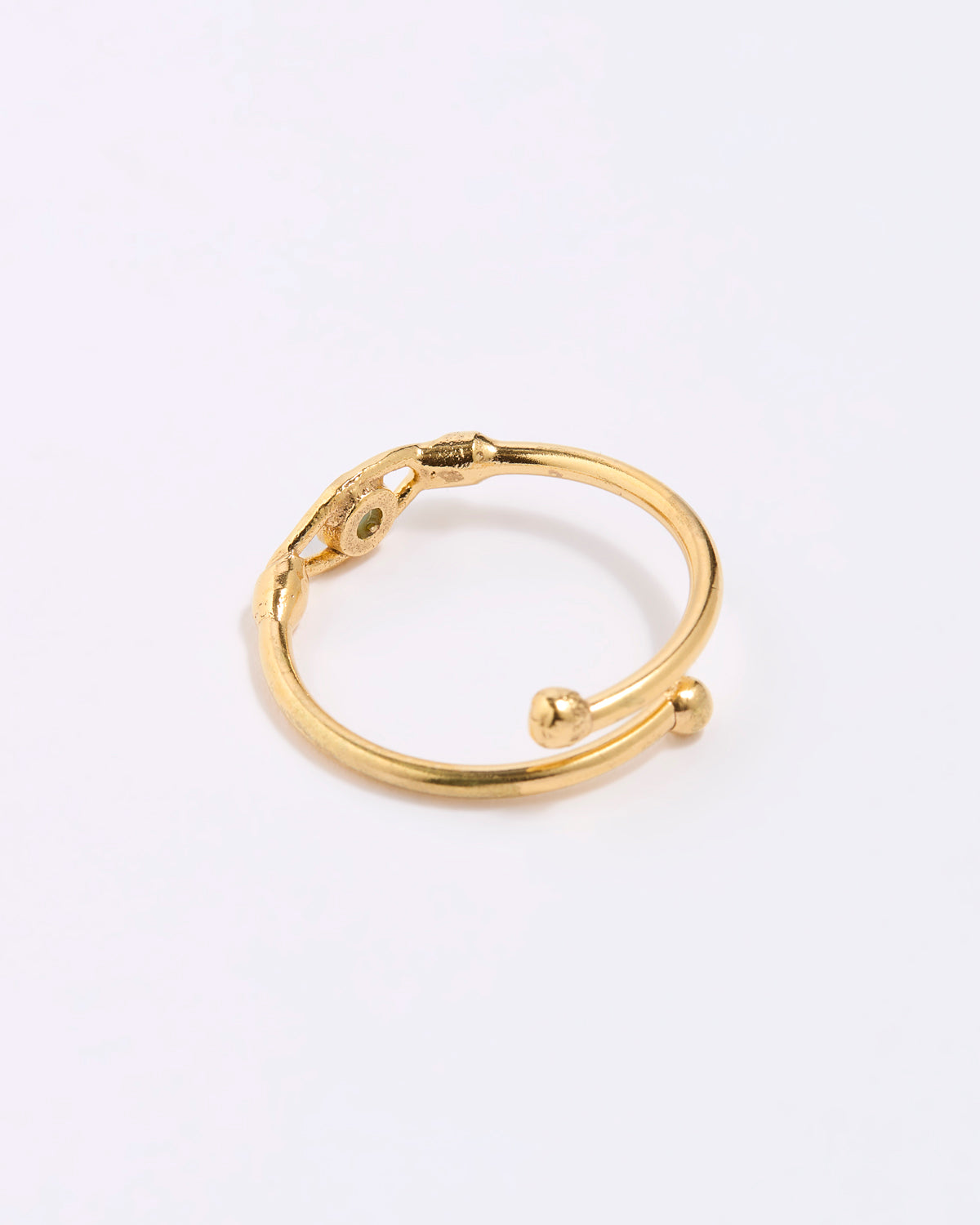 back image of Gold coloured ring with spherical accents on a white background