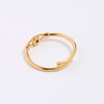 Gold coloured ring on a light gray background