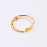 Gold coloured ring on a light gray background