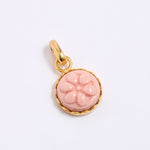 Pink floral pendant with gold frame on a white background