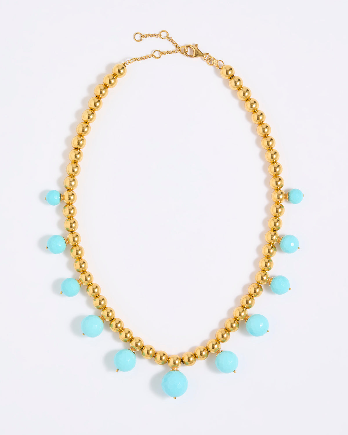Gold coloured beaded necklace with turquoise beads on a white background