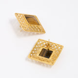 Gold square earrings with intricate designs and tigers eye gemstone, showing reverse of earring on a white background