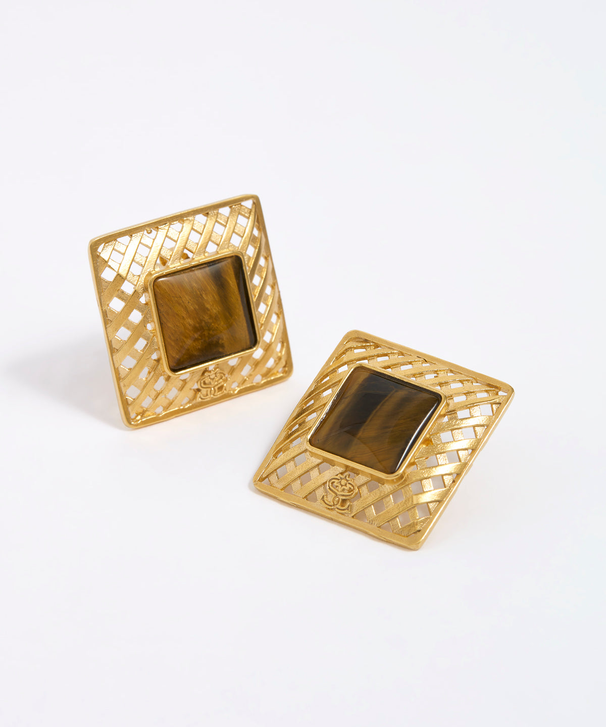 Gold square earrings with a central tigers eye gemstone on a white background