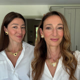 founders of soru jewellery wearing Roma styles in black and white- looking at camera smiling 