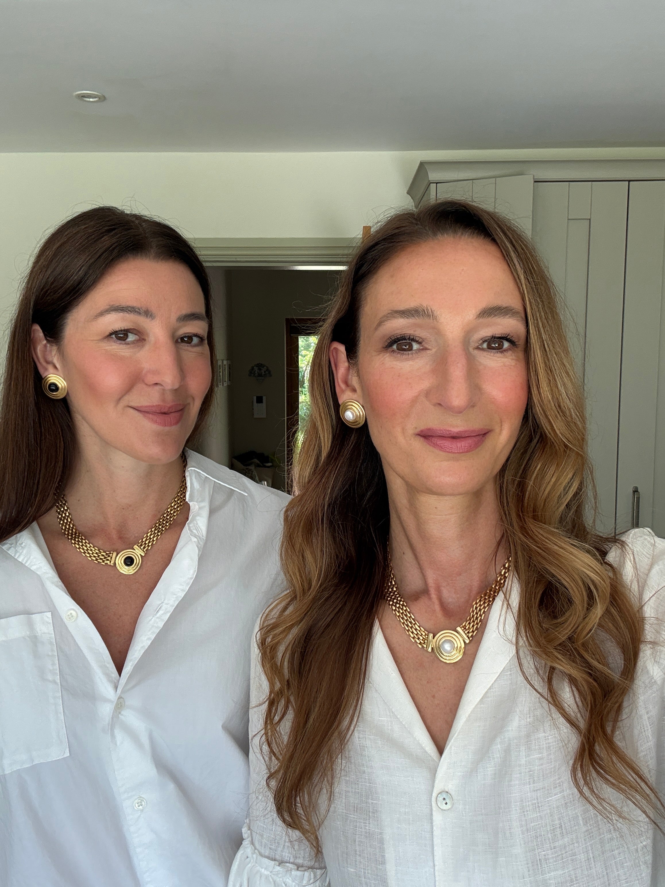 founders of soru jewellery wearing Roma styles in black and white- looking at camera smiling 