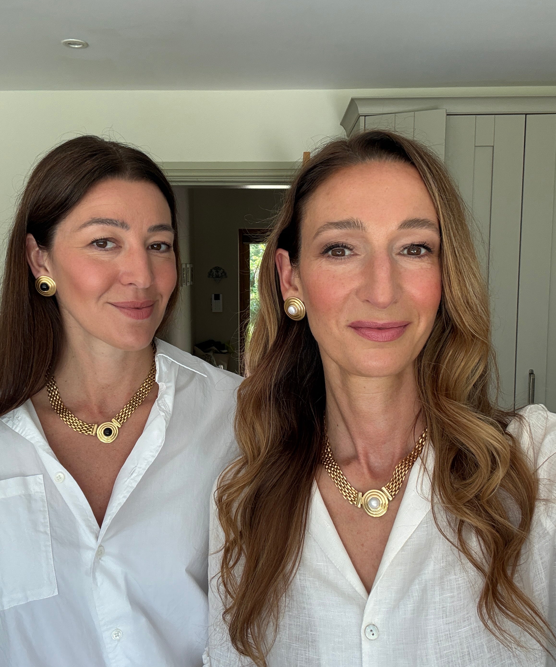 founders of soru jewellery facing towards camera and smiling while wearing Roma style jewellery 