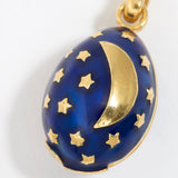 Midnight blue egg shaped charm pendant, with gold star sand crescent moon, on a white background