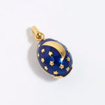 Midnight blue egg shaped charm pendant, with gold star sand crescent moon, on a white background