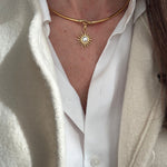 model image of gold coloured choker  with a sun pendant worn.
