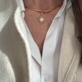 model image of gold coloured choker  with a sun pendant worn.