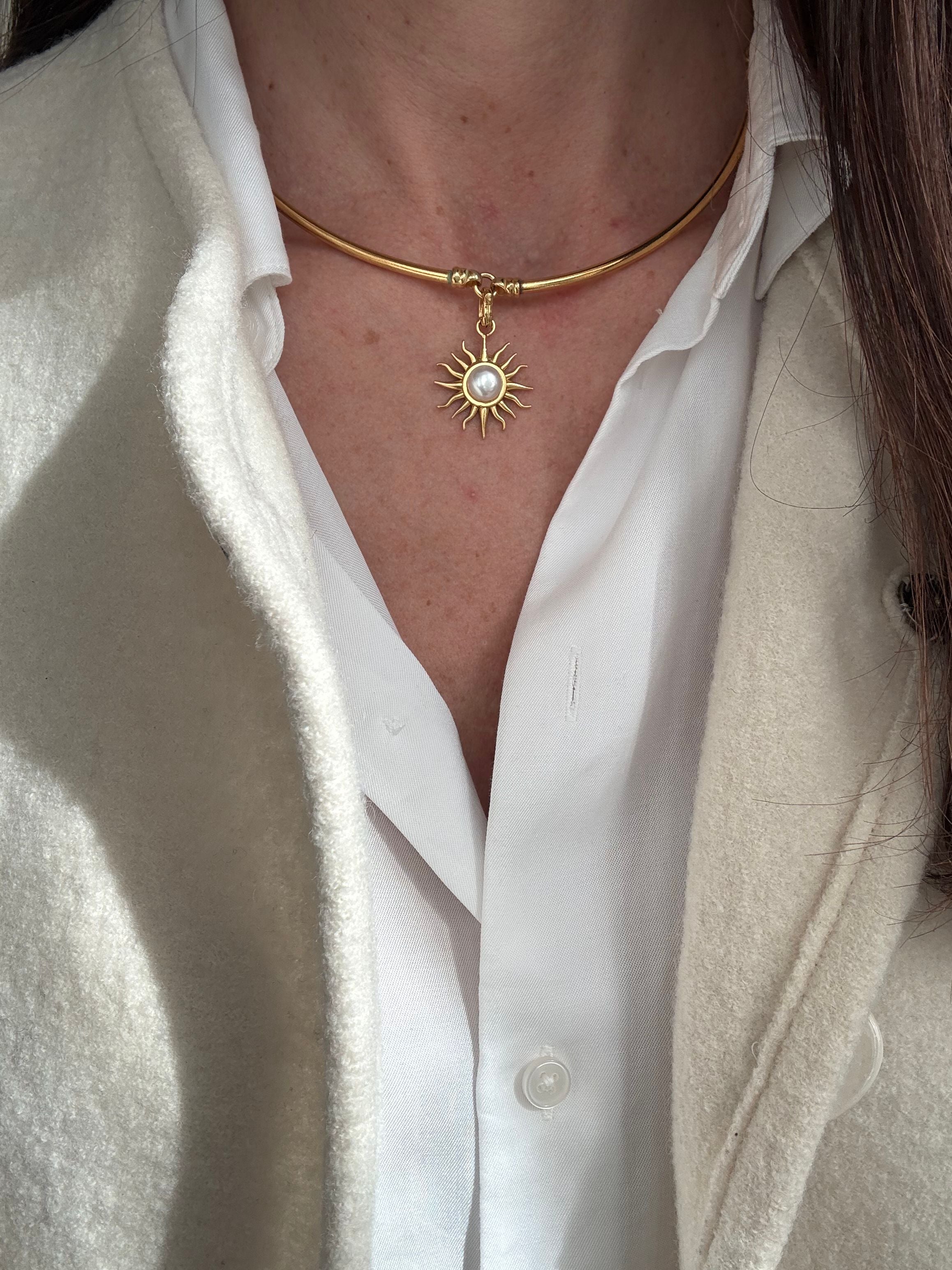 model image of gold coloured choker  with a sun pendant worn.