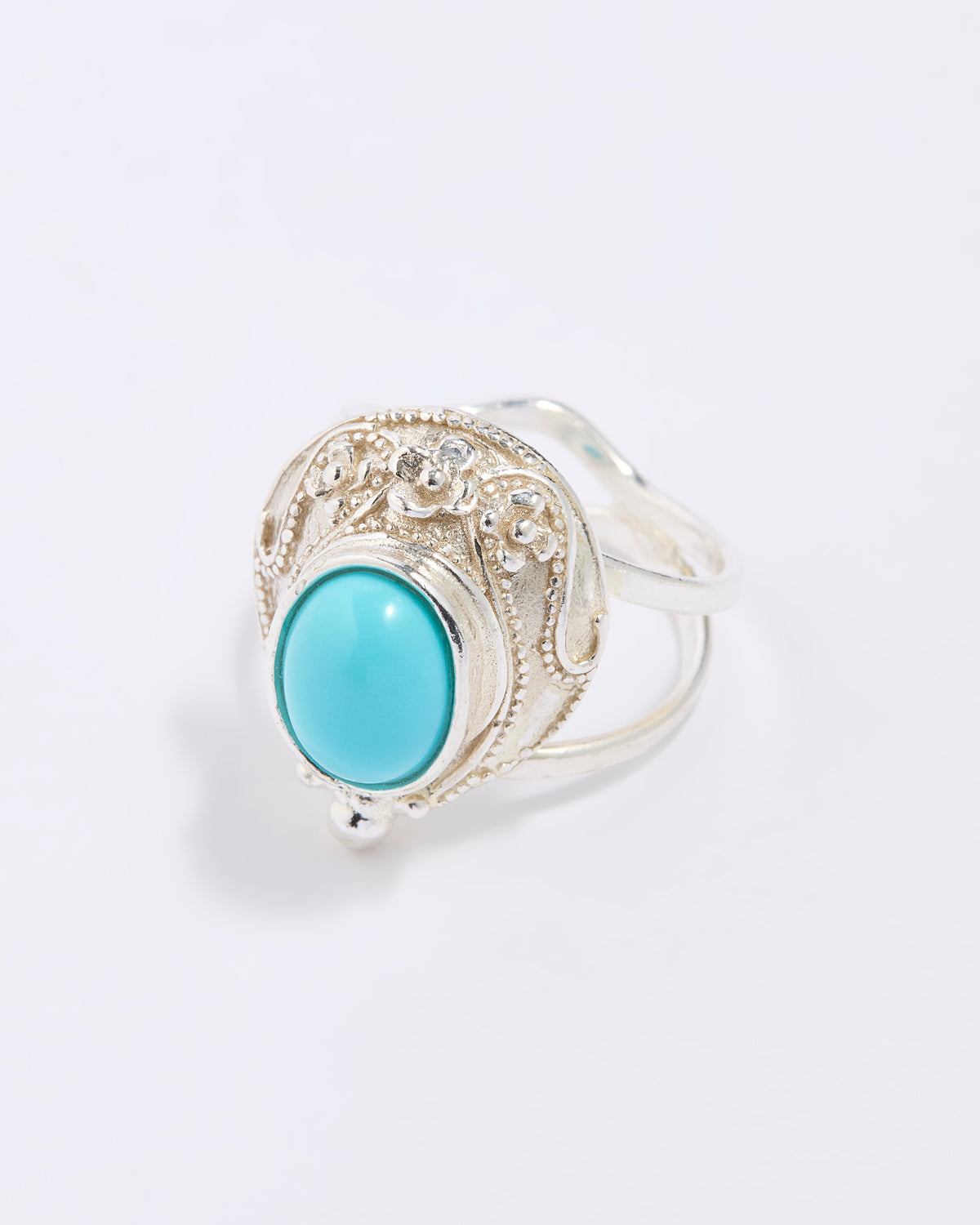 Silver ring with a turquoise stone on a white background