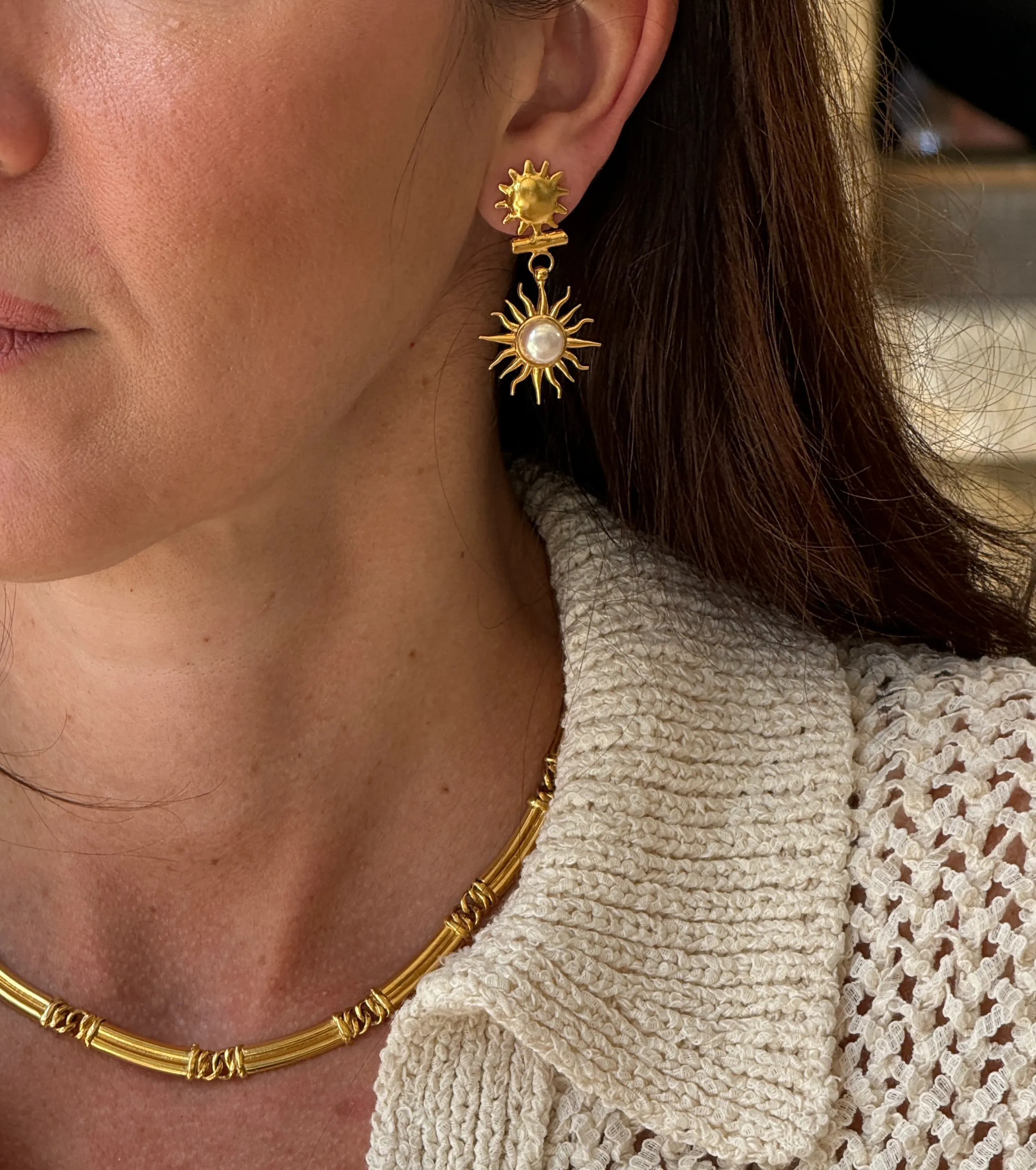 sun drop earrings being worn, close up shot 