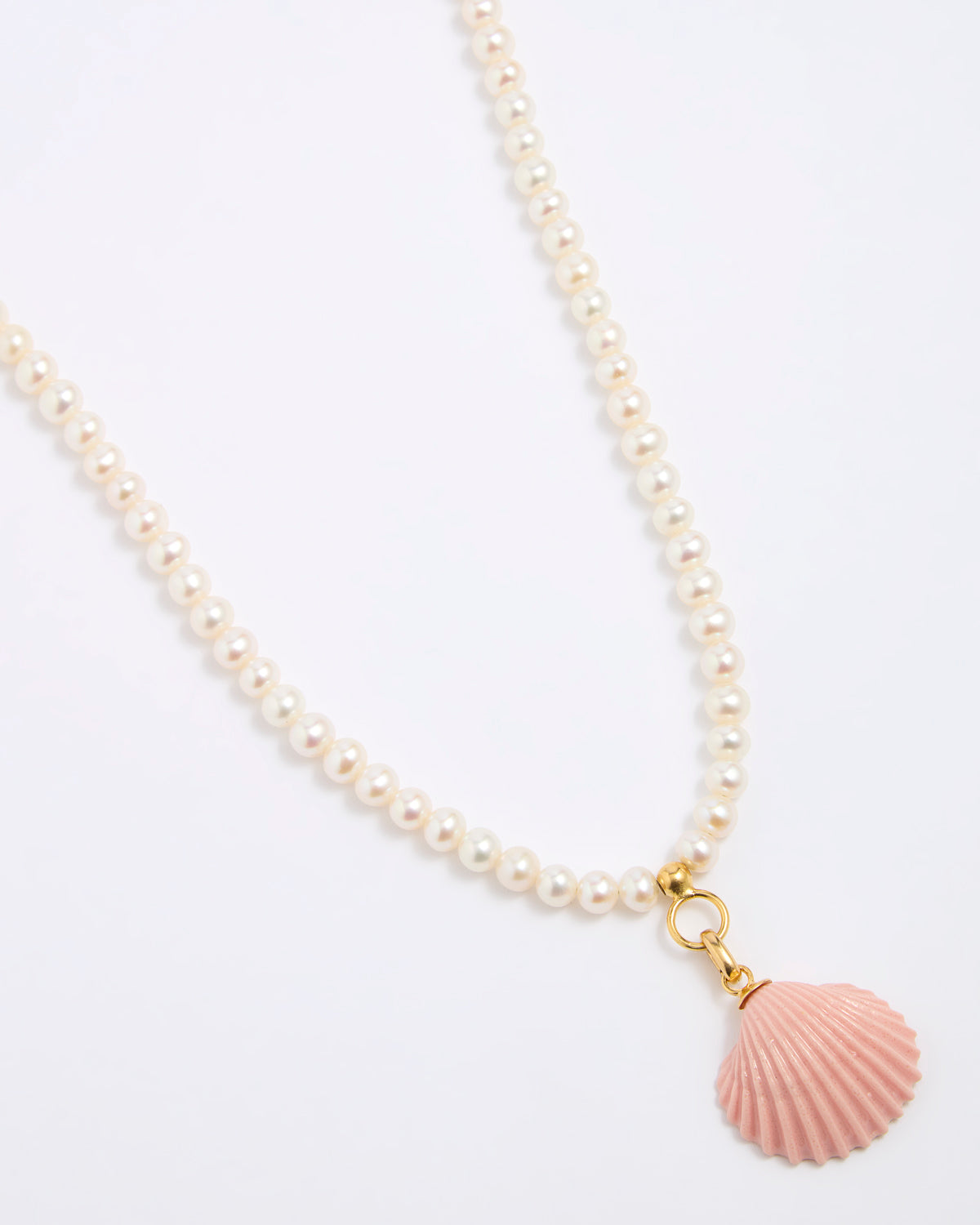 Pearl necklace with a pink shell pendant on a white background