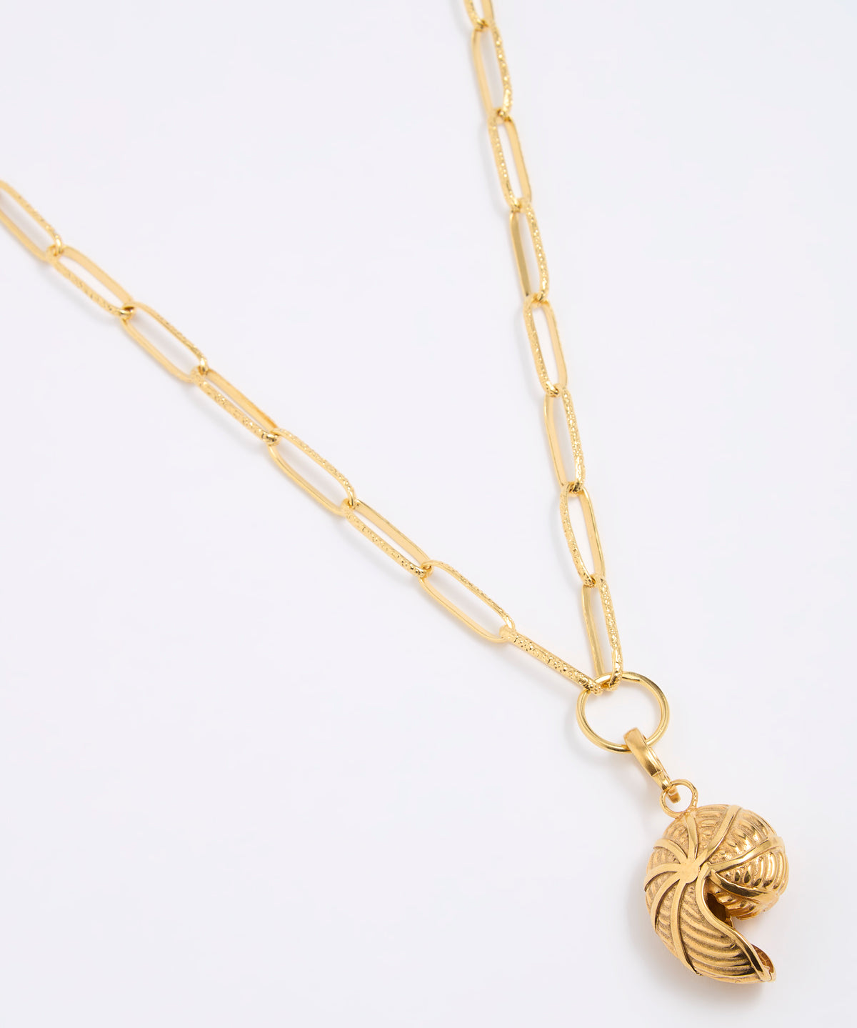 Gold coloured necklace with a shell shaped pendant on a white background