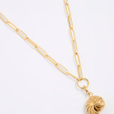 Gold coloured necklace with a shell shaped pendant on a white background