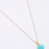 Necklace with a turquoise shell pendant on a white background