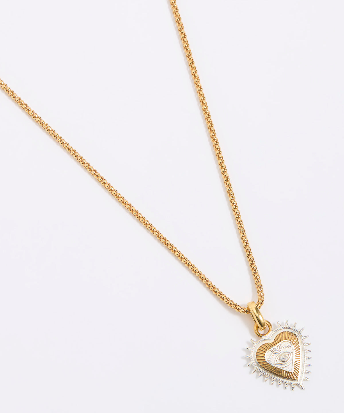 Gold heart-shaped necklace on a white background