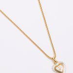 Gold heart-shaped necklace on a white background