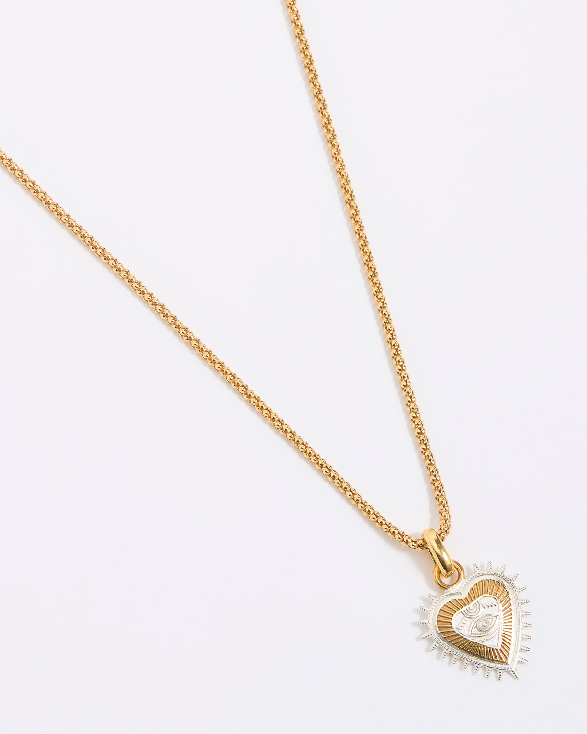 Gold heart-shaped necklace on a white background