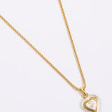 Gold heart-shaped necklace on a white background
