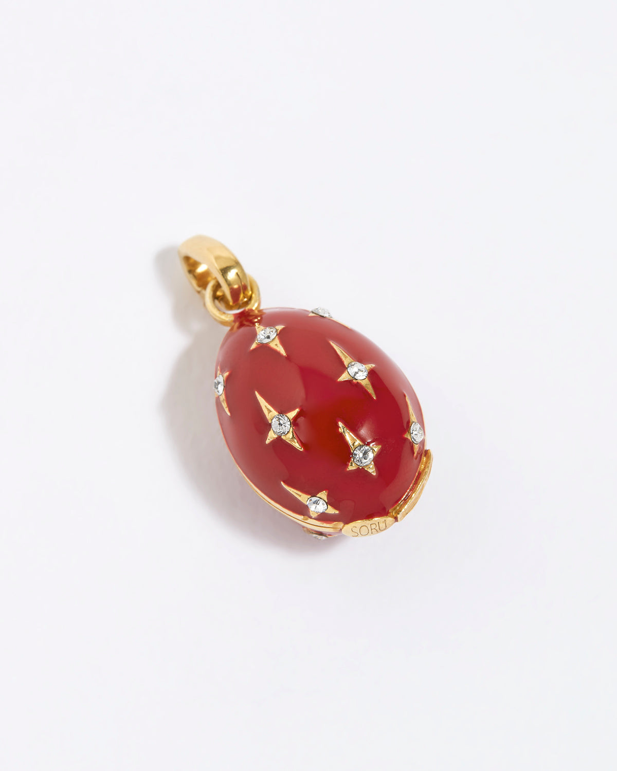Red egg-shaped pendant with gold accents and star designs on a white background