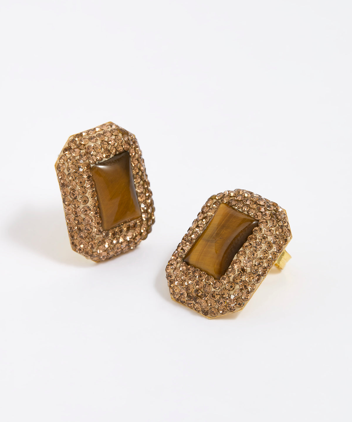 Pair of square stud earrings with brown crystals around a square tigers eye gemstone, on white background