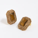 Pair of square stud earrings with brown crystals around a square tigers eye gemstone, on white background