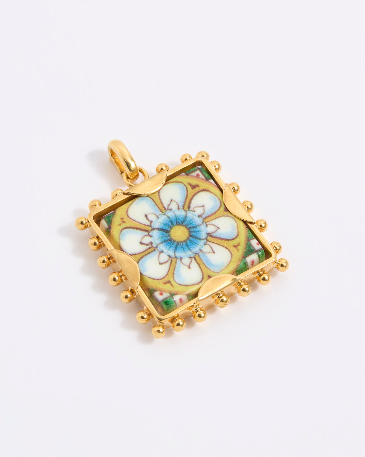 Gold square pendant with a floral tile design on a white background