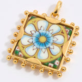 Gold square pendant with a floral tile design on a white background