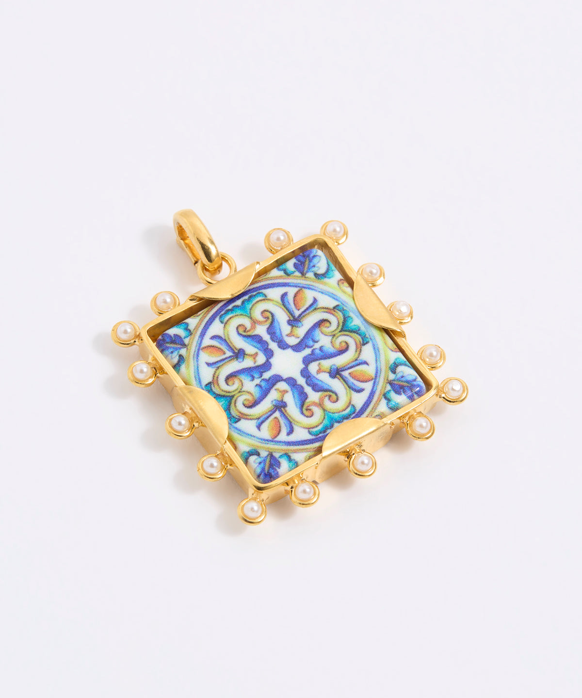 Decorative pendant with blue and gold design on a square tile with mini pearl edging  on a white background