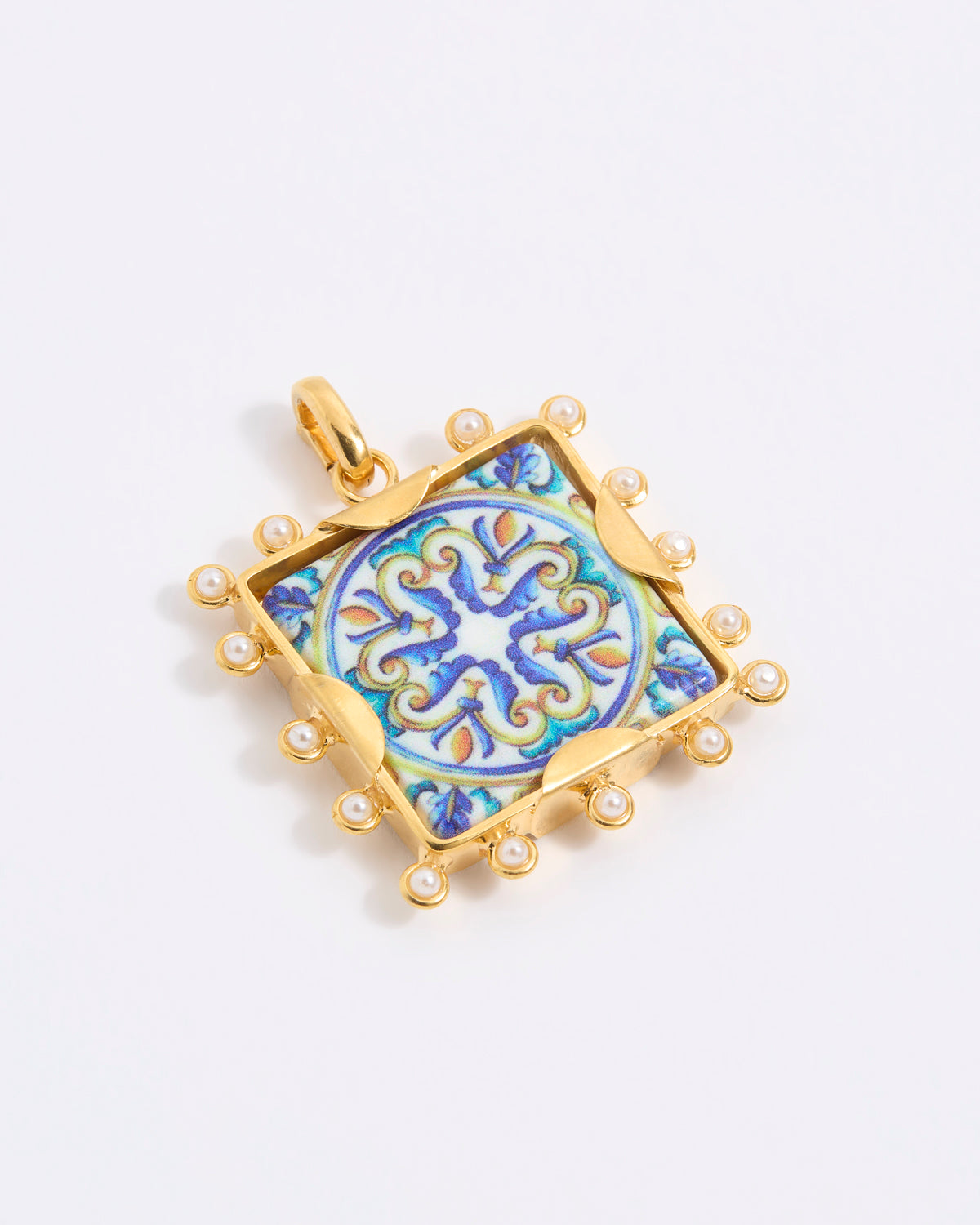 Decorative pendant with blue and gold design on a square tile with mini pearl edging  on a white background