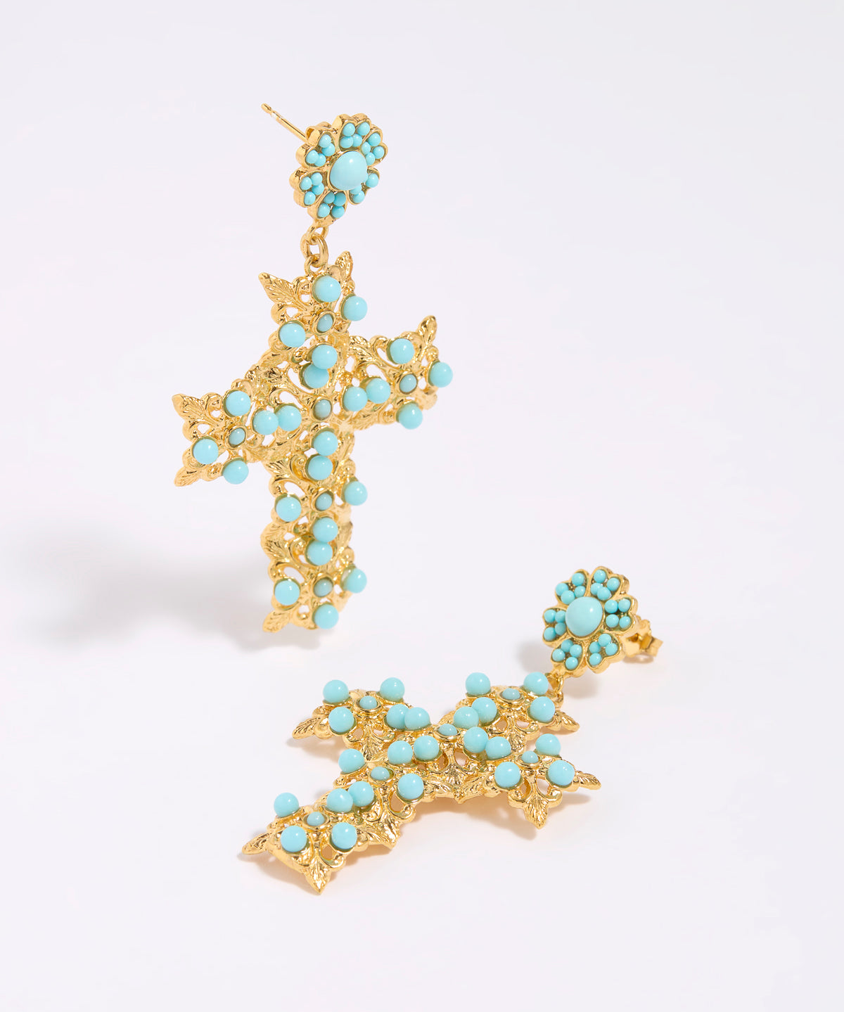 Gold cross-shaped earrings with turquoise stones on a white background