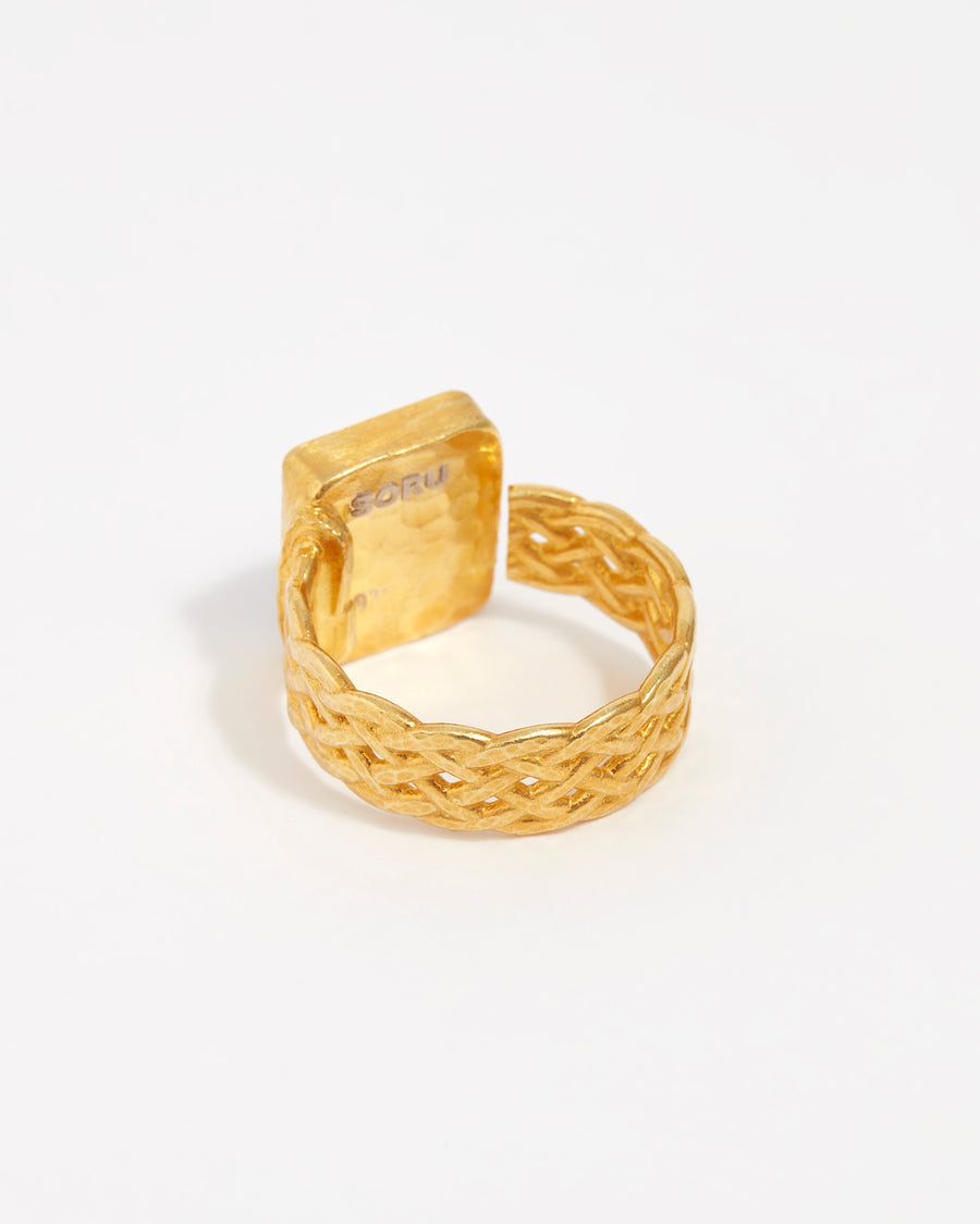 product shot of back of yellow gold plated ring with large green rectangular crystal