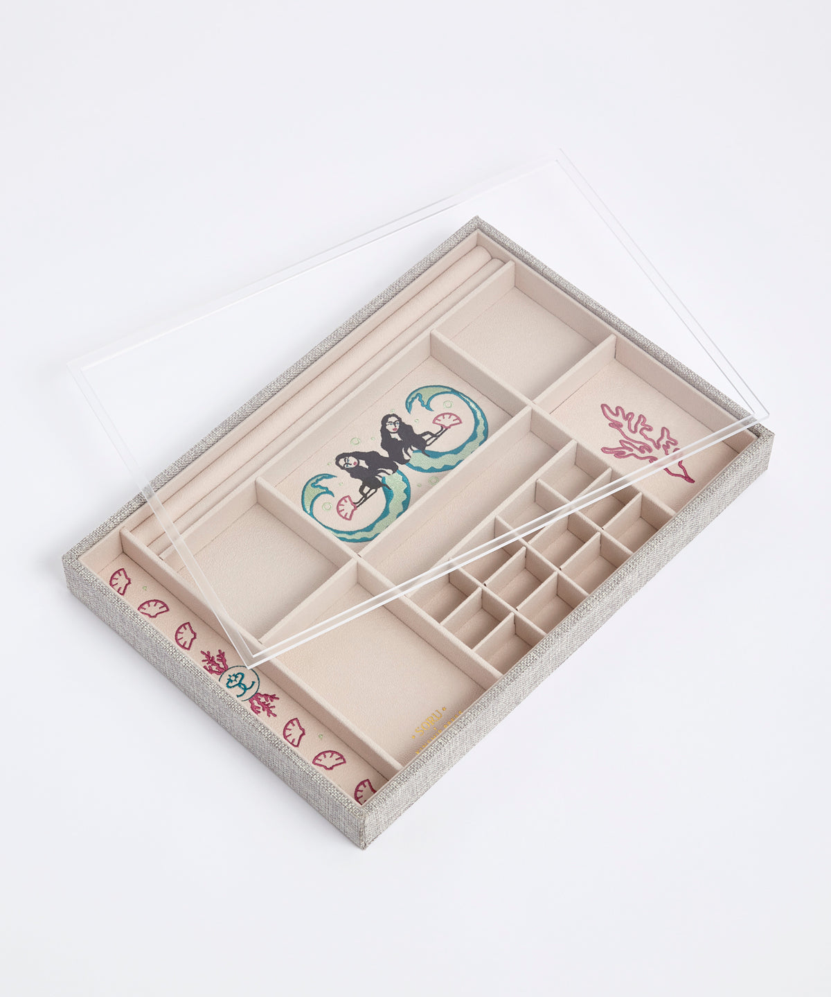 Clear perspex lid on top of the embroidered linen Kinship Press X Soru Treasures Jewellery Tray