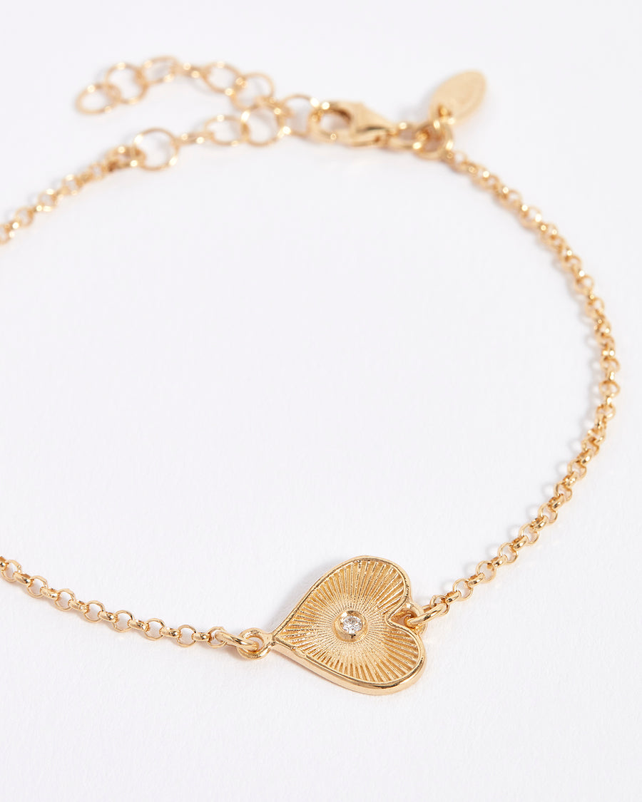 dainty solid gold heart bracelet with diamond centre